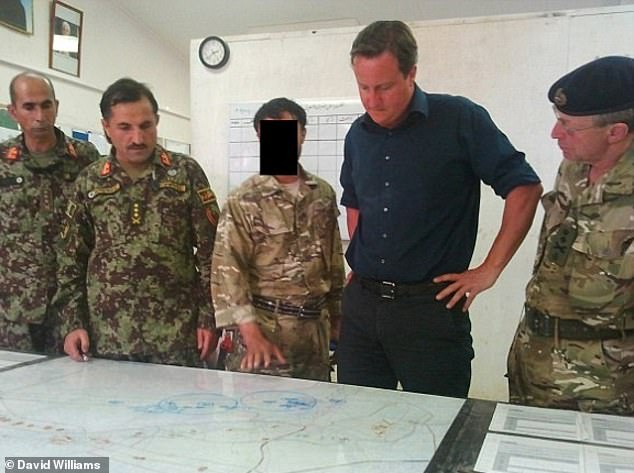 Afghan interpreter 'Shaffy' standing next to David Cameron during the then Prime Minister's visit in 2011. Shaffy was branded a traitor when the Taliban took power