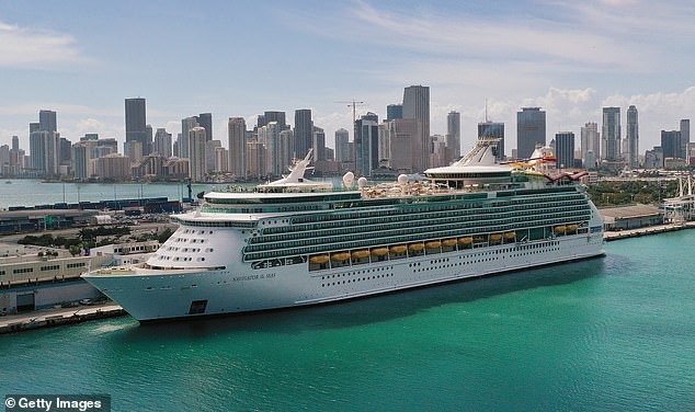 A Royal Caribbean cruise turned into a health crisis for over 140 people aboard the luxury cruise line after a mysterious gastrointestinal illness struck during a voyage. Pictured: An aerial view from a drone shows Royal Caribbean's Navigator of the Sea cruise ship docked