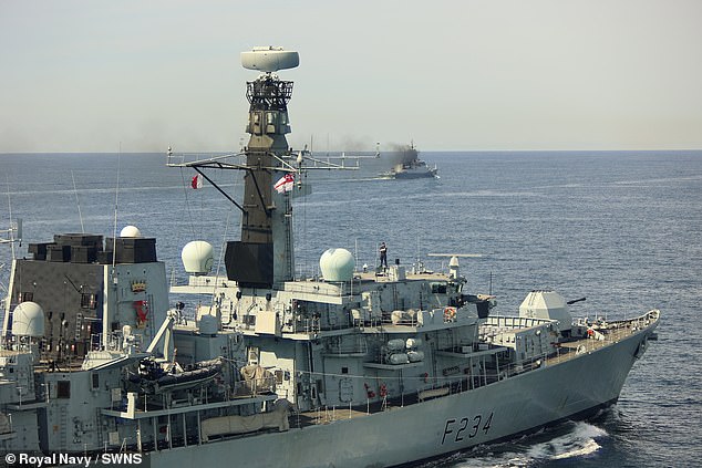 Commanding Officer of HMS Iron Duke Commander David Armstrong atop the ship bridge roof during monitoring of RFN Boikiy
