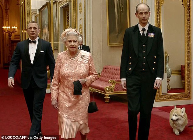 The Queen, with her personal footman Paul Whybrew (right), appeared in a film for the London 2012 Olympics opening ceremony alongside Daniel Craig playing James Bond