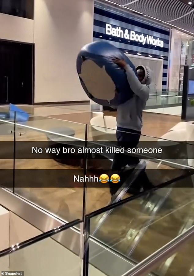 In footage posted on social media, a boy, wearing a grey hoodie, can be seen hurling a blue seat from the top floor down to the bottom