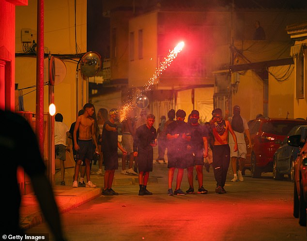 Protesters clash with police on July 13, 2025 in Torre Pacheco, in the province of Murcia, Spain