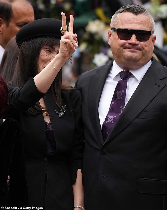 Ozzy's son Louis - from his first marriage to Thelma Riley - (pictured with sister Aimee) also wore a purple tie featuring a skull and crossbones in a nod to his father's own rock n' roll style
