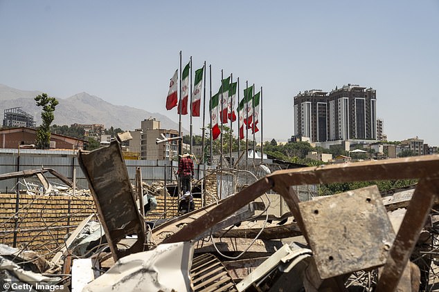 President Donald had an approval rating that remained steady before and after the so-called '12 Day War,' new polling from the Daily Mail showed (Pictured: Workers repair the main entrance of Evin Prison after it was hit by an Israeli airstrike on June 23 in Tehran, Iran)