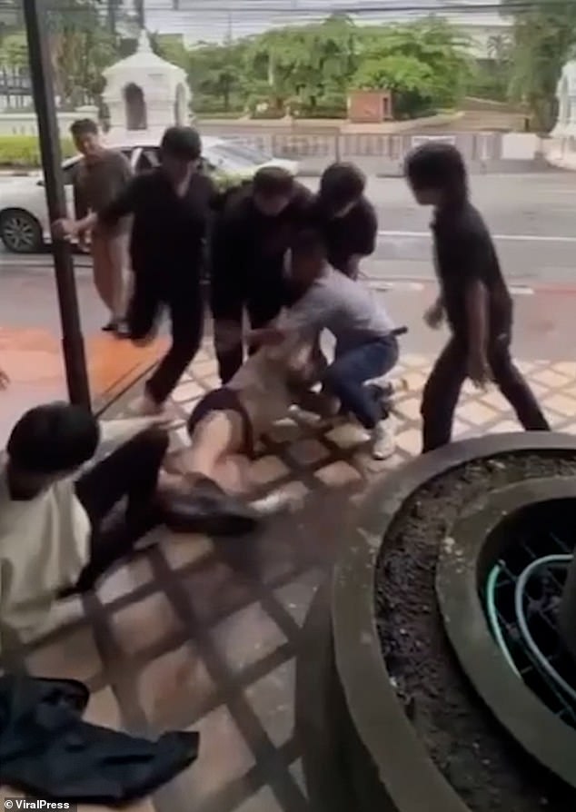 The attackers were filmed trying to rip the man's shirt off and kicking him as he lay on the floor