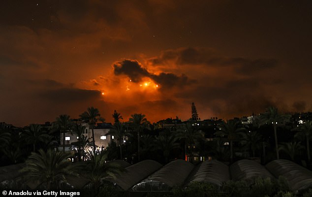 Illumination flares light up the night sky over Gaza during an Israeli ground assault