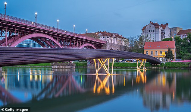 Enjoy a stroll by the River Drava in historic Maribor, which has a large student population