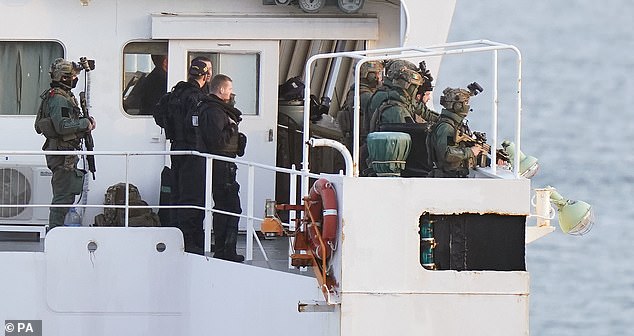 Soldiers are seen on board the drugs cargo ship MV Matthew after seizing it. The vessel had been transporting £132million of cocaine for the Kinahan cartel
