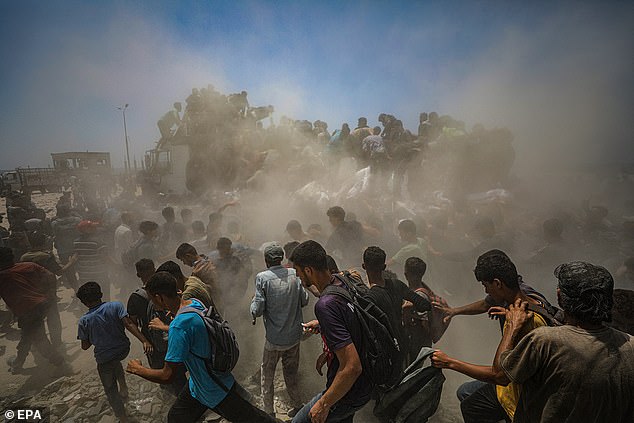 The Prime Minister is under pressure to follow French president Emmanuel Macron in recognising a Palestinian state as horror continues to mount over the conflict. Pictured: Internally displaced Palestinians try to grab bags of flour from an aid truck near a food distribution point in Zikim, northern Gaza Strip, on July 27, 2025
