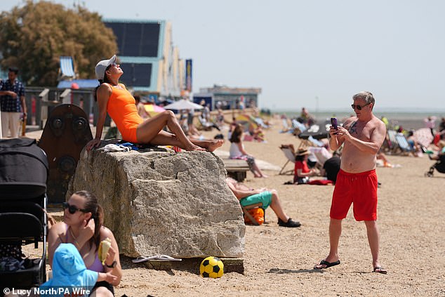 Sunshine helped the high street claw back ground last month with Brits splurging on drinks and days out (pictured, Southend on June 19)