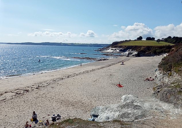 Emergency services were called to Spit Beach (pictured) Car Park, near Par in Cornwall, after reports the 54-year-old had got into difficulty in the water