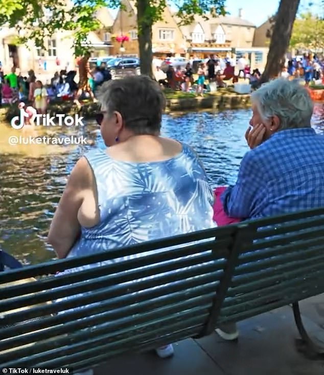 People sit on the bench to look out at the picturesque view