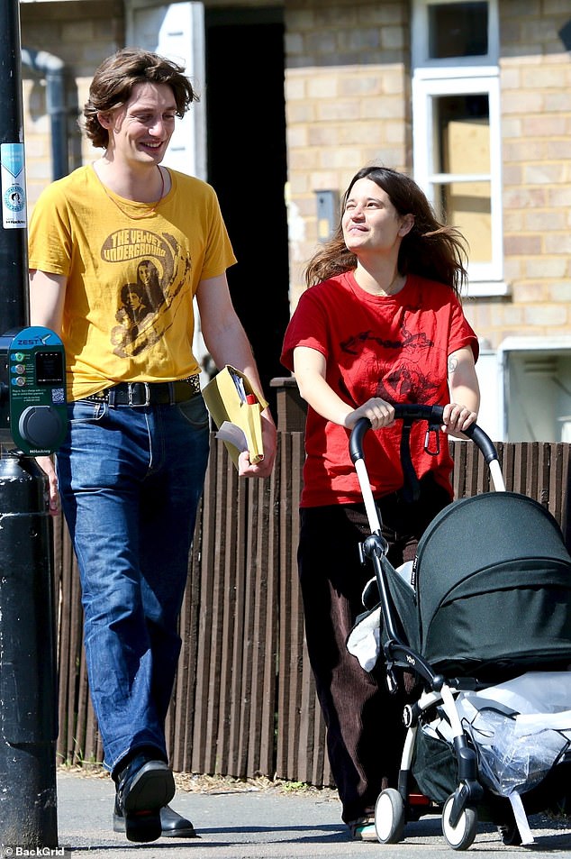 Michael Hutchence's daughter Tiger Lily Hutchence looked like the proud mother as she took her newborn on a family stroll in London on Monday. Pictured Tiger Lily and husband Ben