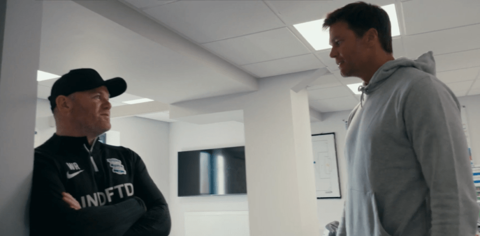 Two men in a hallway having a conversation.
