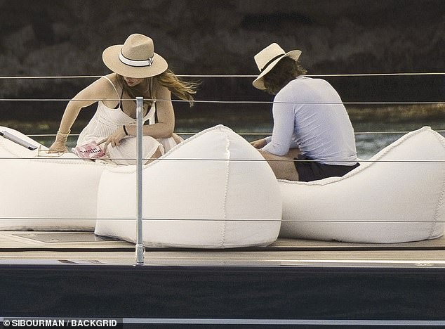 The No Time Do Die actress looked chic in a white lacy dress for her day with Cruise, who showed off his own buff frame in a white shirt and black shorts