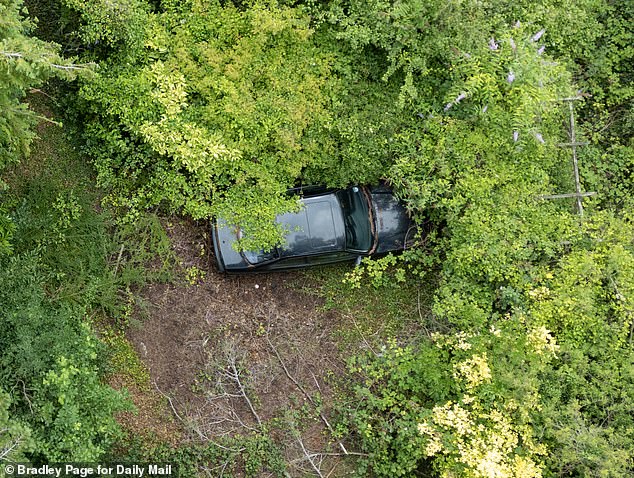When MailOnline visited the abandoned property a vintage BMW 3 series was covered in vegetation