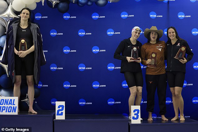 Transgender woman Lia Thomas (L) of the University of Pennsylvania stands on the podium after winning the 500-yard freestyle as other medalists in March of 2022
