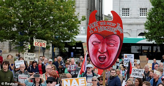 An anti-Trump demonstrator holds a cut-out depicting U.S. President Donald Trump during a rally organised by the campaign group Stop Trump Coalition, protesting the visit of U.S President Donald Trump, in Aberdeen, Scotland, Britain, July 26, 2025. REUTERS/Russell Cheyne
