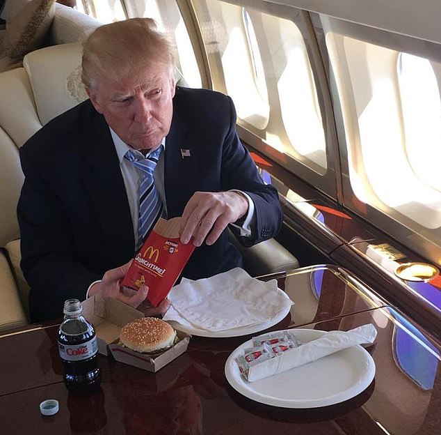 Pictured: Donald Trump eating McDonalds and drinking Diet Coke on board his private jet