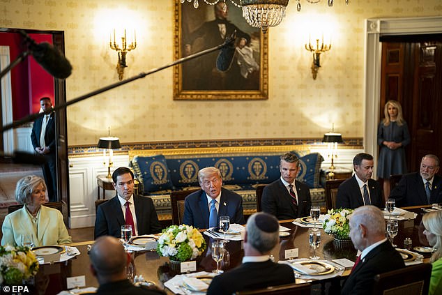 Hegseth could be seen glancing at Trump and nodding repeatedly while the president spoke about Russia 's ongoing attacks on Ukraine