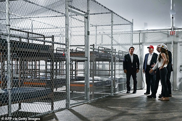 President President Donald Trump, Florida Governor Ron DeSantis (left), and Secretary of Homeland Security Kristi Noem (right) tour a migrant detention center, dubbed "Alligator Alcatraz," located at the site of the Dade-Collier Training and Transition Airport