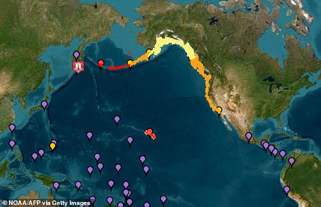 Waves began reaching coastal regions Tuesday evening as evacuation orders spread across Hawaii, Alaska, and beyond