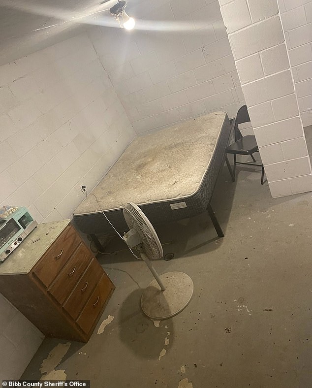 A lone stained mattress with no sheets or blankets was seen stuffed in a corner of the barren and dirty room. A metal chair was placed beside the bed, alongside a standing fan. The only other items in the room were another chair, a small set of drawers