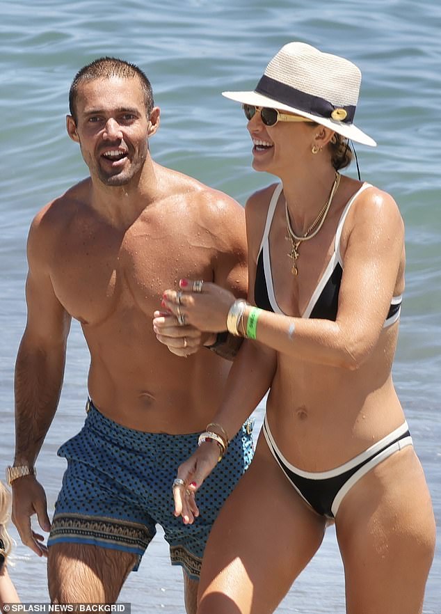 Vogue Williams showed off her incredible figure in a skimpy black and white bikini as she hit the beach in Spain with her family on Sunday