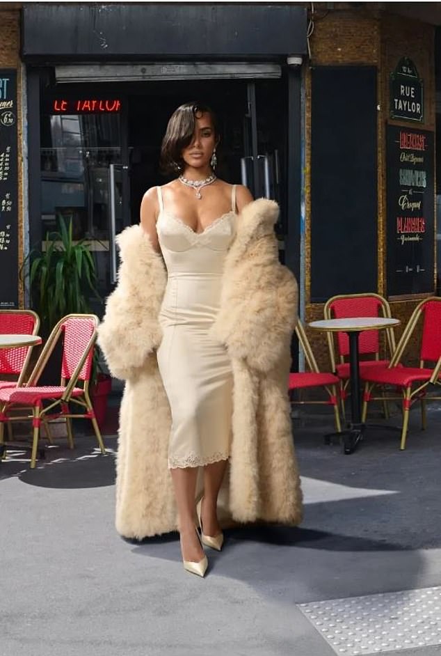 Kim Kardashian cosplayed Elizabeth Taylor, in a feather coat and champagne-coloured satin slip dress inspired by Taylor¿s costume in the 1958 film Cat On A Hot Tin Roof