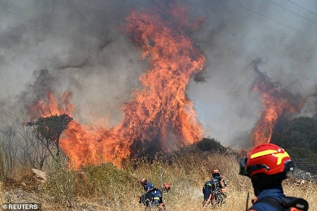 Firefighters try to extinguish flames on the island of Kythira, Greece this weekend. Wildfires are burning through the night in Eastern Europe with more than 50 blazes in Greece alone
