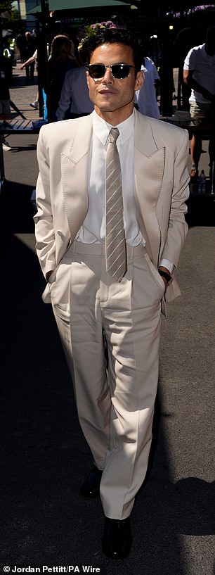 Rami kept it stylish as he opted for a light champagne coloured suit and matching diagonal striped tie