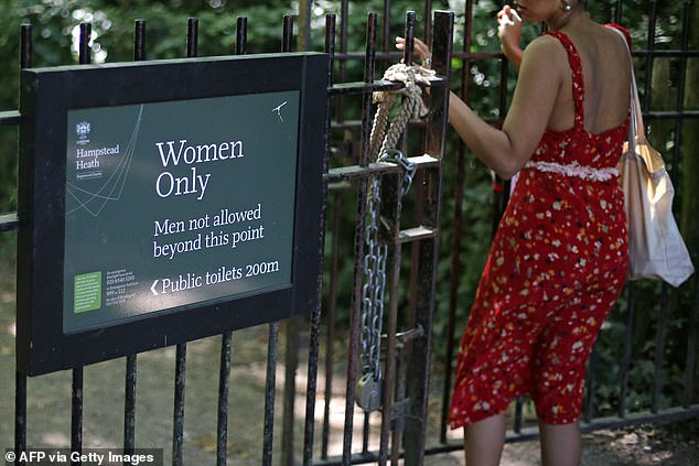 A women's rights group is planning to sue the corporation who run Hampstead Heath Ladies' Pond for £50,000 because they allow transgender bathers in (Pictured: A sign at the pond)