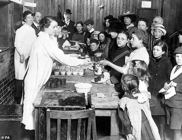 Pictured: A communal 1940s kitchen in operation. World War II style kitchens will open in the UK selling meals for as little as £3 to help disadvantaged areas