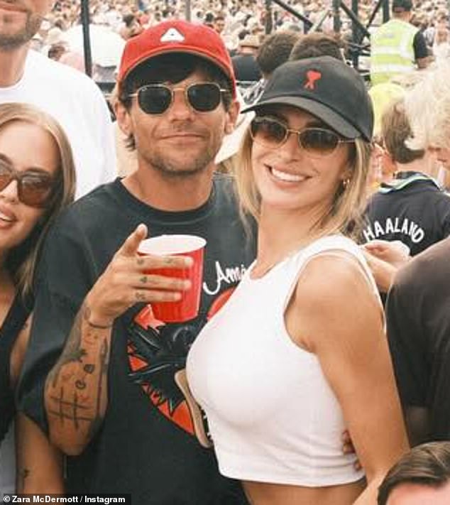 Louis could be seen with his arms wrapped around Zara who flopped her head back onto his shoulder, while enjoying the music