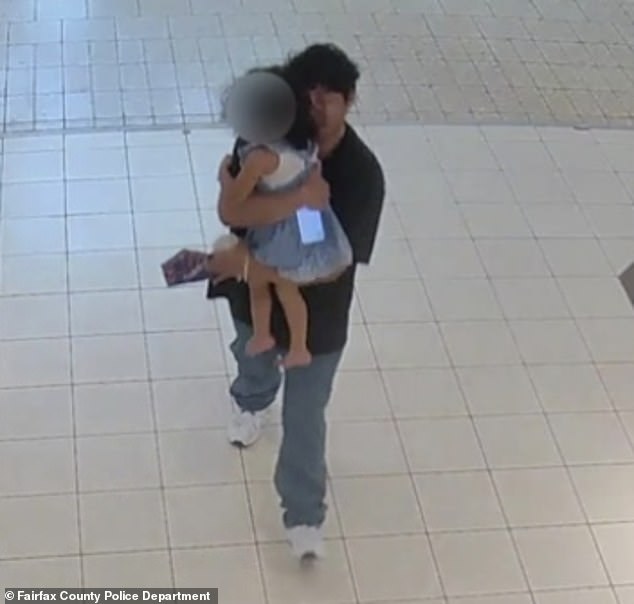 He quickly swoops down and grabs the girl, quickly making his way inside JC Penney with her in his arms