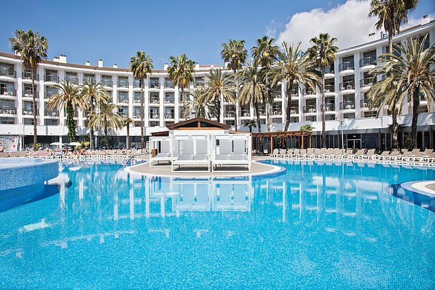 The hotel boasts a huge pool surrounded by dozens of reclining sun loungers and exotic palm trees