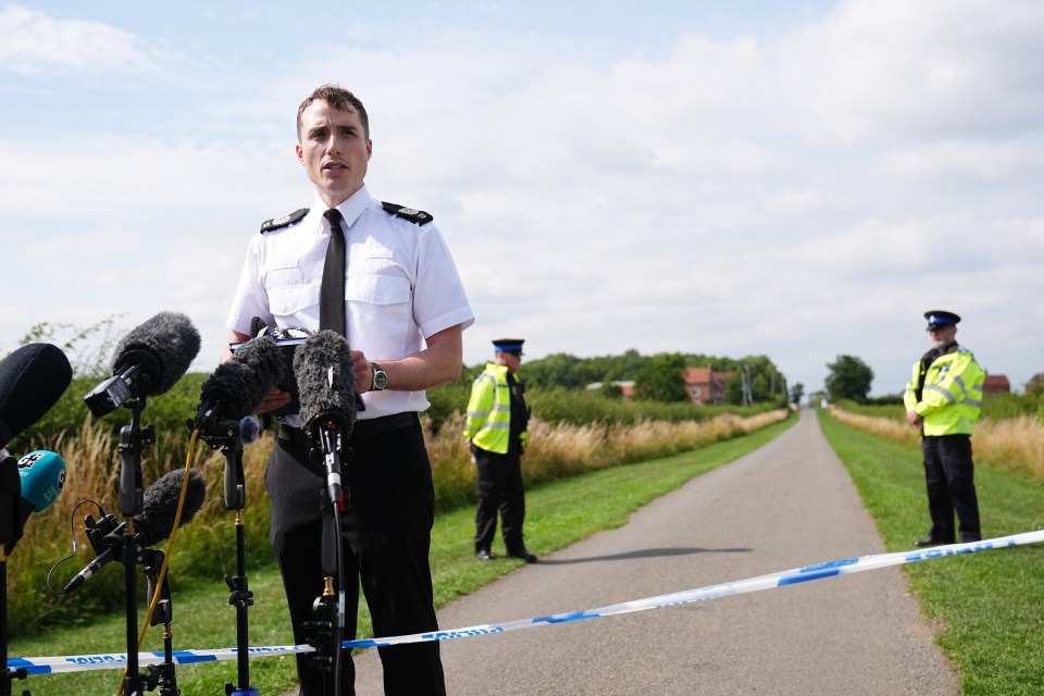 Police officer giving a press conference.