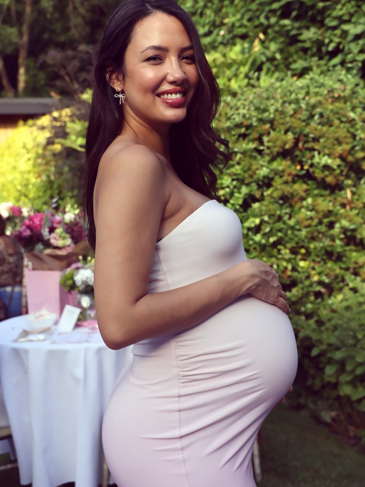 Pregnant woman in a light pink dress.