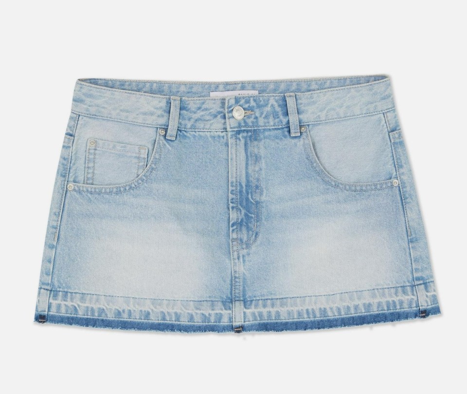 Light wash denim mini skirt with frayed hem.