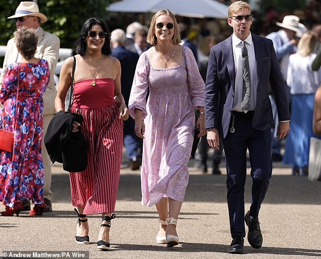 Two friends were spotted wearing summer frocks in vibrant shades of red and pink, pairing their dressed with wedge espadrilles