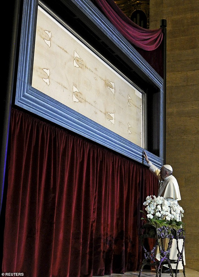 The shroud first appeared in 1354 in France. After initially denouncing it as a fake, the Catholic church has now embraced the shroud as genuine. Pictured, Pope Francis visits the Shroud of Turin in 2015