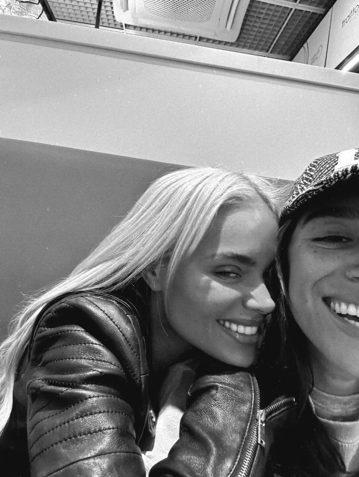 Black and white photo of two women embracing.