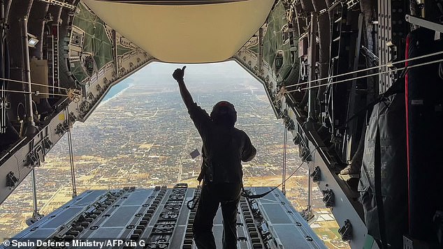 This image shows a crew member gesturing after the successful release of humanitarian aid from a Spanish Air Force Airbus A400M Atlas airplane over Gaza