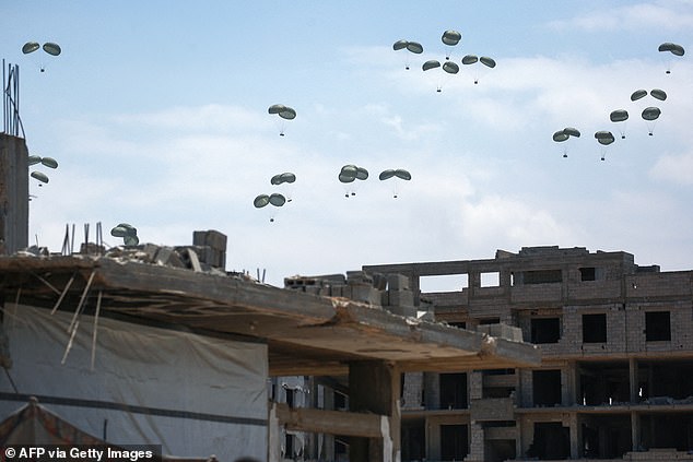 A picture taken in northern Gaza's Jabalia shows aid parcels prachuted down following an airdrop above the Israel-besieged Palestinian territory on August 1