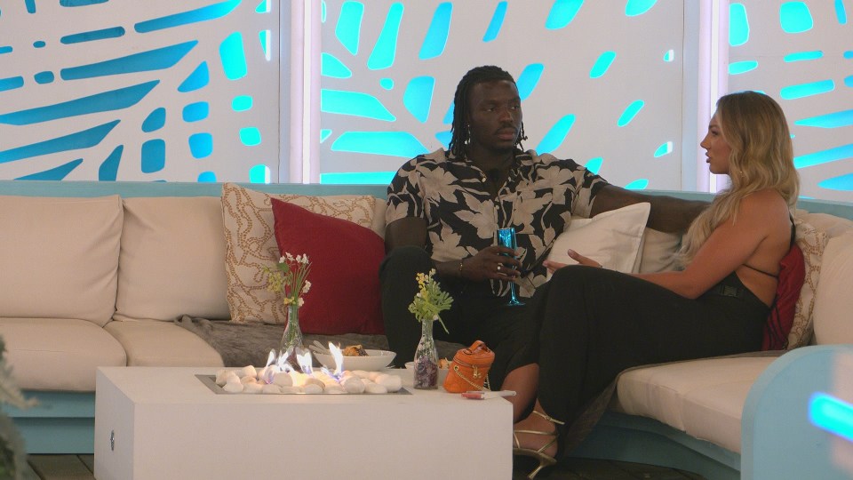 Dejon and Meg on a Love Island couch.