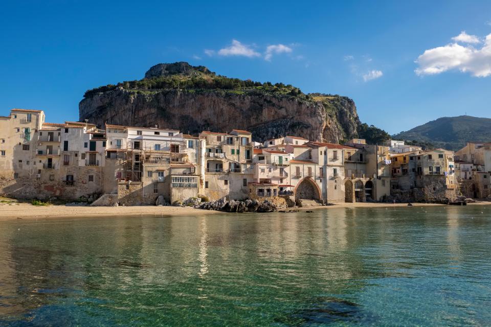 Medieval fishermen's houses on a beach in Cefalu, Sicily.
