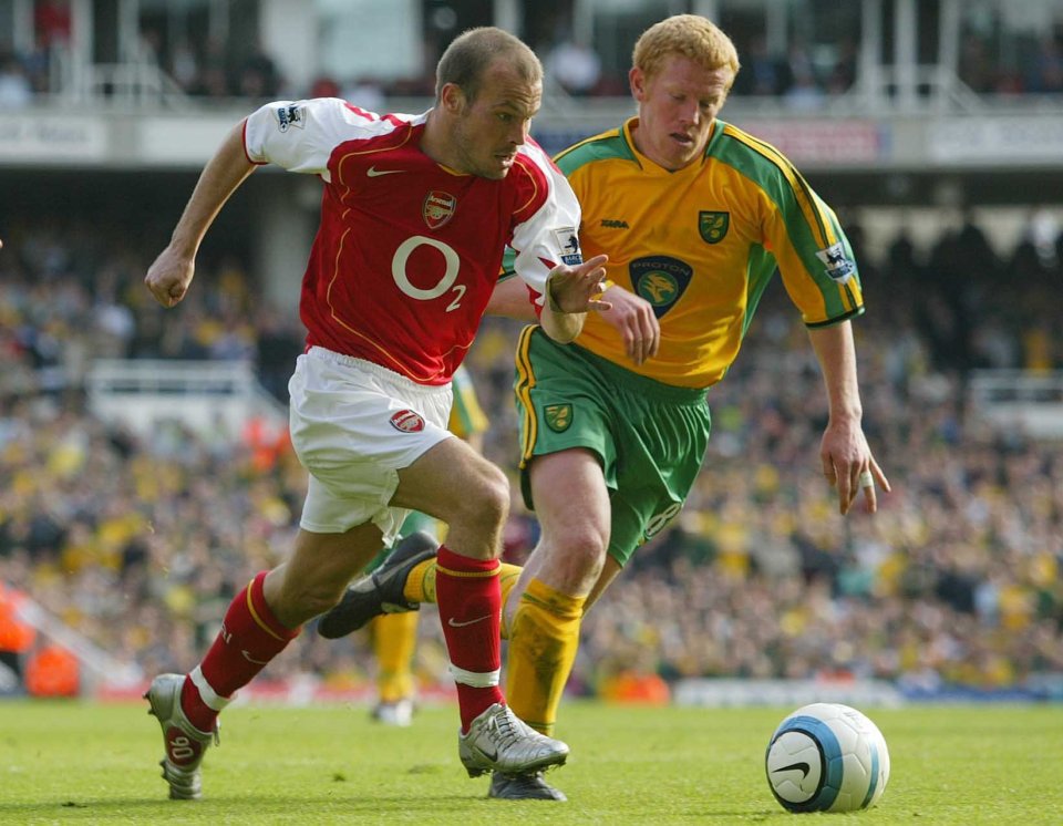 Arsenal's Freddie Ljungberg and Norwich's Gary Holt vying for the ball.