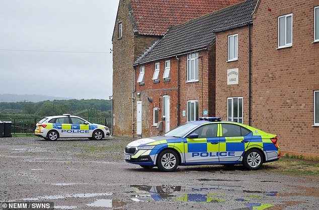 A police car at the site - neighbours said there had been police activity at the property since Monday