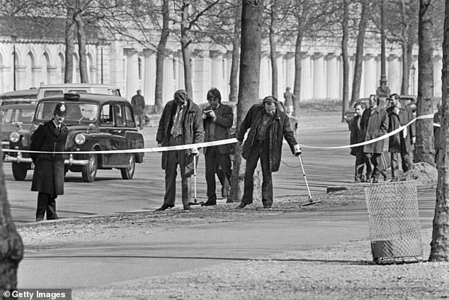 Police searching the Mall for bullets near Buckingham Palace in London, after the attempt to kidnap Princess Anne