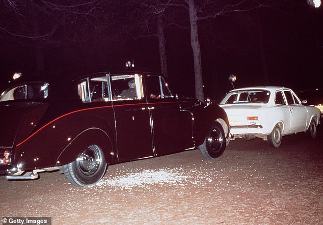 Ball's white Ford Escort blocking the Princess's limousine as shattered glass can be seen on the ground